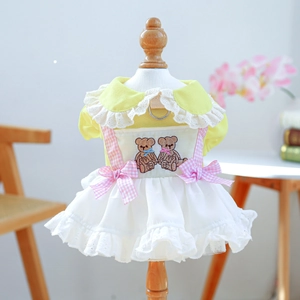 Detail of yellow pet princess dress with pink bow and delicate lace embroidery accents