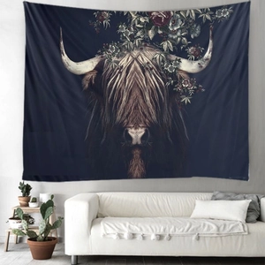 Detail of bohemian tapestry featuring a realistic highland cow with floral crown above sofa