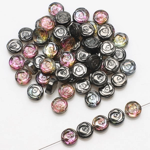 Macro shot of 10mm glass rose beads with iridescent gold and black finish for DIY jewelry