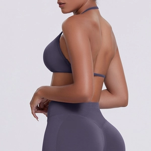 Close-up of seamless dark purple sports bra and high-waist leggings with halter back detail
