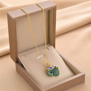 Elegant jade-green Ruyi pendant necklace with gold chain and enamel details in a gift box