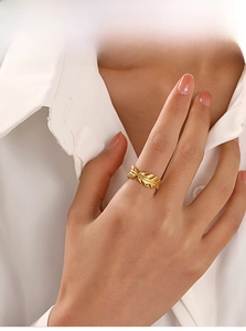 Detail shot of golden leaf ring with clear vein textures on a model finger