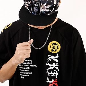 Detail of minimalist O-link chain necklace worn with a streetwear printed t-shirt