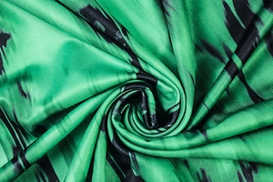 Detailed macro view of premium emerald silk fabric with abstract black stripes