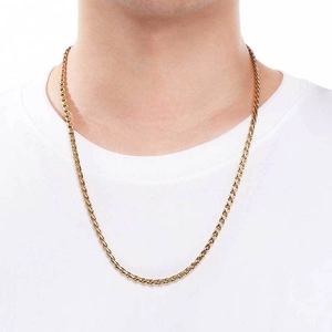 Detail view of 4mm golden dragon bone chain necklace worn by a male model on white background