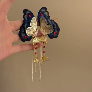 Vintage style butterfly earrings with blue embroidery, gold tassels, and crystal accents
