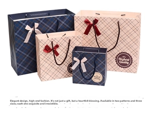 Detail of dark blue and pink checkered gift bags with ribbon bows in three sizes