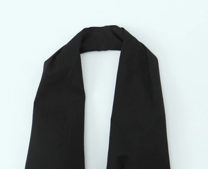 Detail view of black knit fabric belt accessory with soft textured woven material