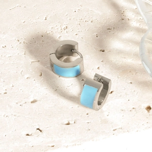 Detail of silver stainless steel hoop earrings with light blue enamel inlay and stone