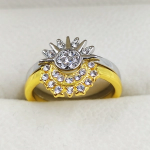 Macro detail of celestial sun and moon rings with sparkling white rhinestones on velvet