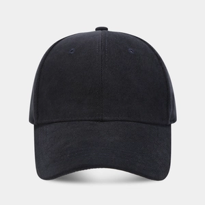 Detailed close-up of a black cotton baseball cap showing stitch lines and six-panel crown