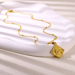 18K gold plated tarot sun pendant necklace with delicate beaded chain on white surface