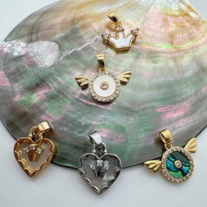 18K gold plated pendants with mother of pearl in crown and heart shapes on shell base