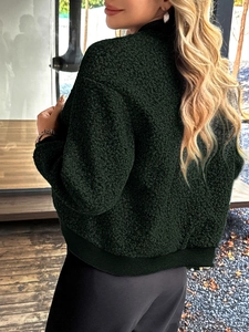 Rear view of dark green fleece jacket featuring stand collar and ribbed cuffs and hem