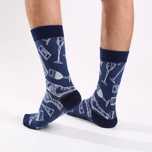 Detail of dark blue crew socks with white wine bottle pattern shown on feet from a side view