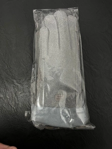 Gants d'hiver gris avec garniture en fausse fourrure dans un emballage plastique