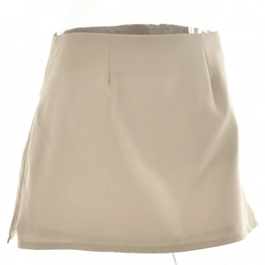Detail view of a minimalist beige high-waist mini skirt shown on a studio mannequin