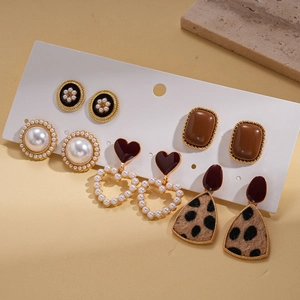 Detail of 5-pair earring set featuring resin, faux pearls, and vintage geometric studs