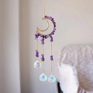 Detail of amethyst moon suncatcher with golden wire wrap and crystal prisms