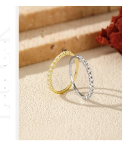 Close-up of gold and silver S925 sterling silver eternity rings with paved sparkling crystals