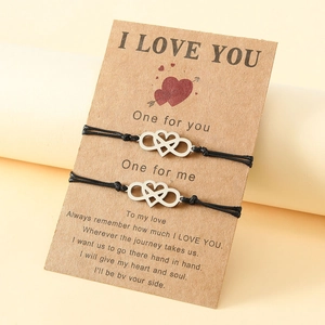 Detail of couple bracelets on card with heart and infinity charms on woven ropes