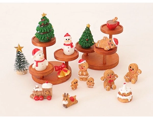 Miniature Christmas resin figurines with gingerbread men and snowmen on wooden display stand