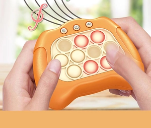 Close-up of hands playing the orange quick push game console for reaction training