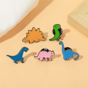Set of 5 cartoon dinosaur enamel pins including T-Rex and Triceratops on warm background