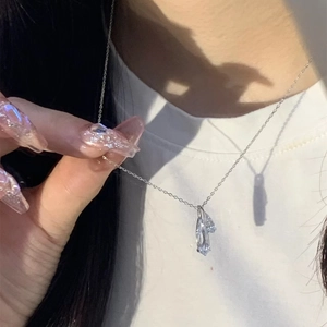 Close-up of double water drop zircon pendant on silver S925 chain worn on neckline