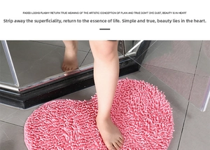 Close-up of pink heart-shaped chenille bathroom mat with soft absorbent plush texture