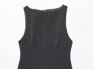 Close-up of charcoal grey sleeveless dress showing textured fabric and round neckline