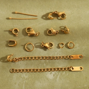 Macro view of 18K gold plated lobster claws, jump rings and extension chains set
