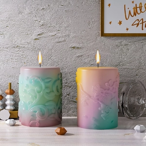 Detailed relief patterns on gradient pillar candles with floral and scroll textures