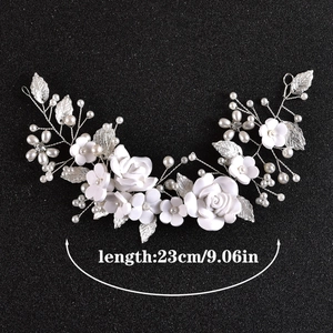 Detail view of 23cm bridal hairpiece with white clay flowers and silver alloy leaves