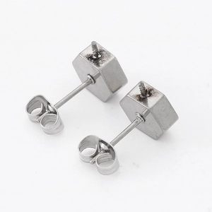 Pair of silver hexagonal stud earrings showing the back structure and butterfly clasps