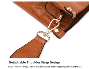Detail of brown litchi leather tote with detachable strap and gold spring buckle