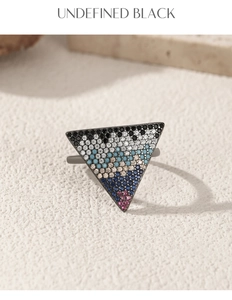 Macro shot of a triangular S925 silver ring with colorful gradient pavé crystals
