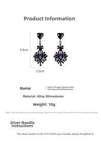 Macro shot of black heart earrings with sparkling rhinestones and silver needles detail
