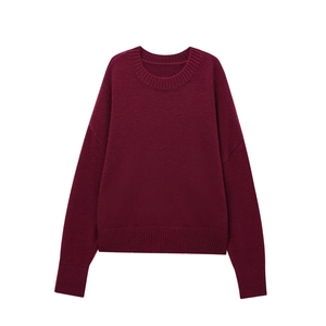 Detail of burgundy crewneck knit sweater showing ribbed cuffs and premium wool texture