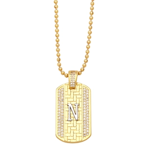 Detailed shot of golden rectangle N pendant necklace with woven texture and crystals