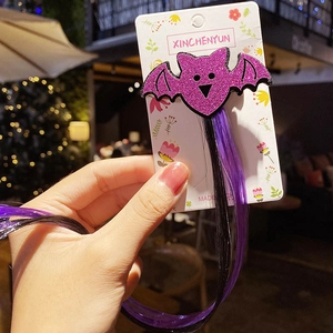 Detail of Halloween hair clip with purple glitter bat and bicolor hair extensions
