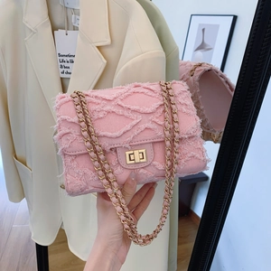 Elegant pink denim crossbody bag with gold chain strap and fringed detail stylish woman handbag