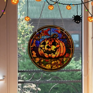 Macro detail of pumpkin acrylic pendant with metal chain for Halloween window decor