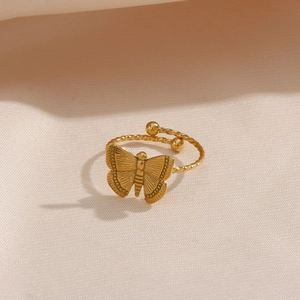 Detail shot of golden 18K gold-plated butterfly ring with adjustable rope band texture