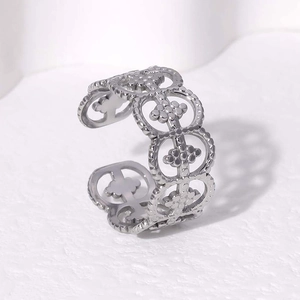Close-up of adjustable stainless steel ring with hollow clover pattern and bead texture