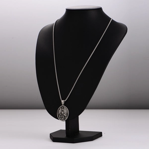 Vintage Fatima embossed stainless steel pendant necklace on black display bust