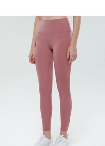 Detail of high-waisted yoga leggings in dusty rose with seamless peach lift stitching