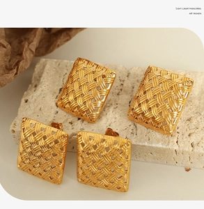 Detailed view of square woven texture gold-plated stainless steel earrings on stone