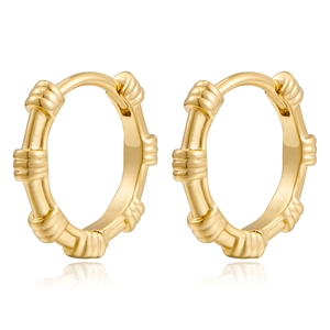 Detailed close-up of gold geometric hoop earrings with textured bamboo-style design