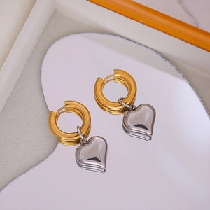 Two-tone heart drop earrings in gold-tone hoops with polished silver-finish heart charms